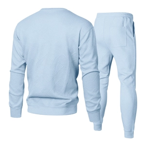 Detail of light blue men's tracksuit set with geometric textured knit fabric on back
