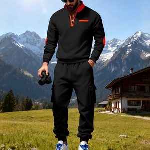 Details eines schwarzen Herren-Trainingsanzugs mit orangefarbenen Reißverschlüssen