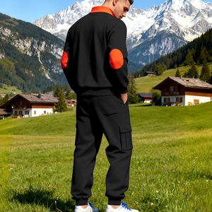 Detail eines Herren-Trainingsanzugs in Schwarz mit orangefarbenem Kragen und Cargo-Taschen