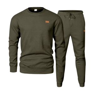 Detail of olive green athletic suit featuring geometric embossed texture and square leather patch