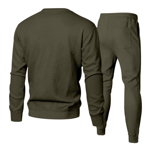 Back view of men's olive green tracksuit featuring geometric quilted texture and ribbed cuffs
