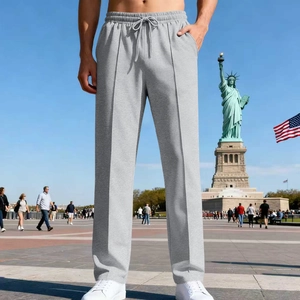 Detail of light grey men's athletic jogger pants with drawstring waist and vertical seam