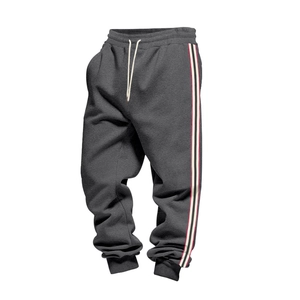 Detail of grey men's joggers with drawstring waist and tri-color side stripes