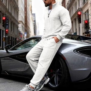 Detail of men's white cable knit tracksuit with half-zip collar and ribbed cuffs