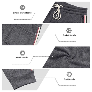 Detailed views of dark grey joggers with elastic drawstring waist and side stripe accents
