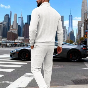 Rear view of men's white track suit with textured V-knit fabric in urban street setting