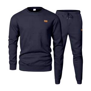 Detailed texture of navy blue men's tracksuit with 3D geometric jacquard pattern