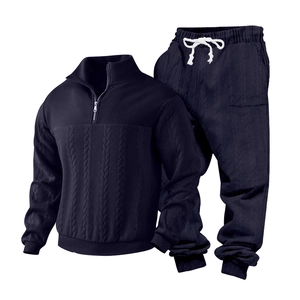 Detail of navy knit track suit showing cable textures and half-zip collar design