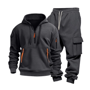 Detail of dark grey tactical track suit featuring orange zipper and cargo pockets