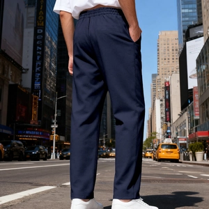 Men's navy blue casual straight-leg pants with elastic waist shown in city street