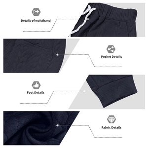 Navy blue cable knit joggers featuring elastic drawstring waist and side pocket details
