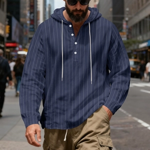 Detail of navy blue striped linen hoodie with white buttons and drawstring hood