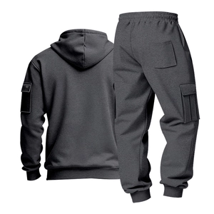 Detail of dark grey men's tracksuit featuring cargo pockets and ribbed cuffs