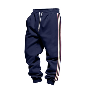 Detail of dark blue joggers featuring drawstring waist and triple-stripe side paneling