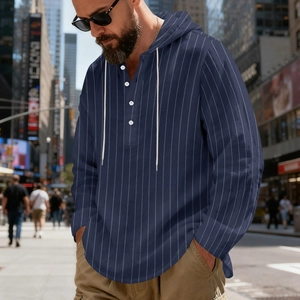 Detail shot of the navy striped linen hoodie featuring a buttoned collar and drawstrings