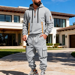 Detail of men's grey tracksuit with orange zippers on hoodie and cargo pants