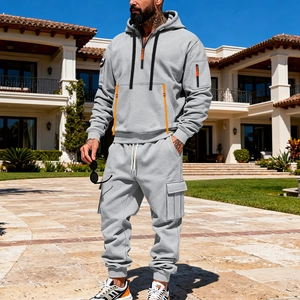 Detail view of a men's grey casual tracksuit with orange accents and cargo pants pockets