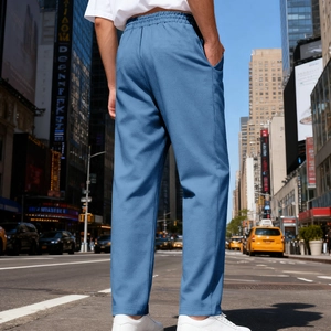 Detail of men's blue casual trousers with elastic waist and urban street style