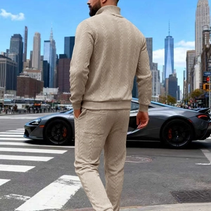 Detail of men's beige knitted tracksuit featuring waffle texture and ribbed cuffs