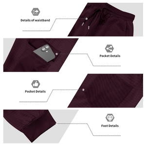 Detailed view of waffle textured wine red joggers with drawstring waist and cargo pockets