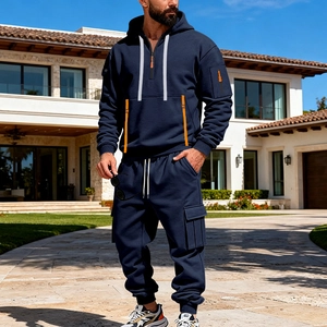 Detail of navy blue techwear tracksuit with orange zipper accents and cargo pockets
