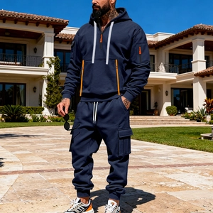 Detail of navy men hoodie with orange zipper and cargo pants in outdoor setting