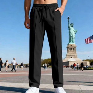 Detail of men's black joggers featuring an elastic drawstring waist and distinct leg seam