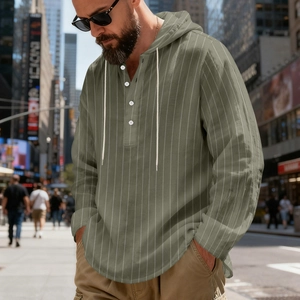 Detail of olive green striped linen hoodie shirt with white drawstrings and henley buttons