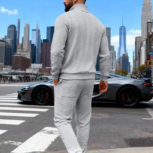 Detail of light gray men's tracksuit with textured herringbone fabric and ribbed cuffs