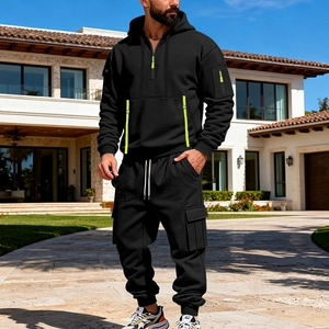 Detail of men's black tracksuit with neon green accents and cargo pockets on trousers