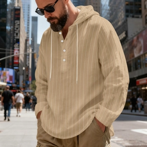 Detail of light brown striped linen hoodie shirt with button placket and drawstring hood