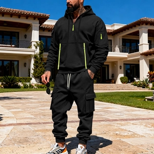 Detail of black hoodie with neon yellow zipper accents and cargo pockets on sleeve