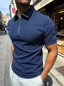 Men's navy slim fit polo shirt with half-zip collar and waffle texture in street setting
