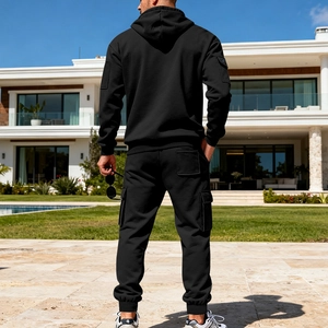 Men's black cargo hoodie tracksuit featuring side utility pockets and heavy knit texture