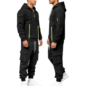 Detail of men's black tracksuit with cargo pockets and neon green zipper accents