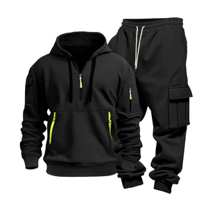 Detail of black men's hoodie set featuring neon green zipper and cargo pocket accents