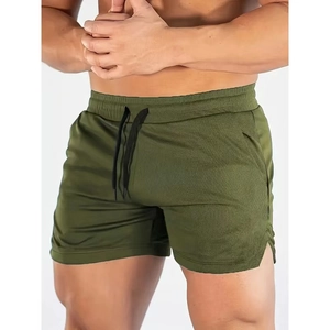 Detail of army green sports shorts featuring mesh texture and side slit for fitness