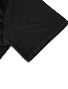 Close-up of black polo shirt sleeve featuring breathable honeycomb mesh fabric and stitching