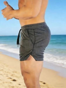 Close-up of quick-dry men's sports shorts with adjustable drawstring and side split design