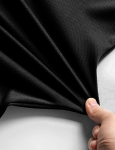 Close-up of black breathable mesh fabric showing honeycomb texture and elastic knit detail
