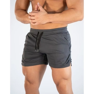 Detail of grey mesh fabric texture and black drawstring on men's athletic shorts