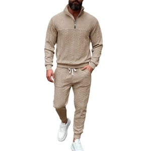 Men's two-piece beige leisure suit featuring textured knit pattern and half-zip collar