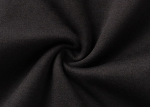 Close-up macro of black knitted fabric texture with smooth weave for men hoodie