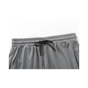 Close-up of elastic waistband and black drawstring on gray breathable mesh shorts