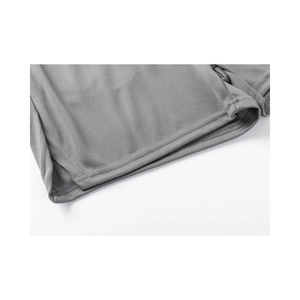 Detail of gray athletic shorts showing breathable mesh fabric texture and double-stitched hem