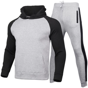 Men's two-piece tracksuit featuring grey raglan hoodie and jogging pants with side stripes
