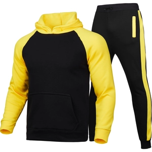Men's two-piece tracksuit featuring black and yellow contrast hoodie and striped joggers