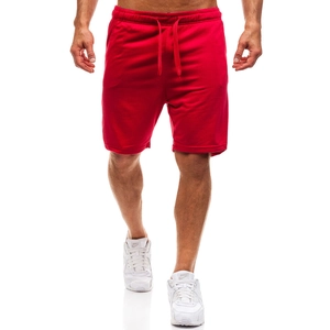 Detailed close-up of men's red sports shorts featuring an elastic waistband with drawstrings