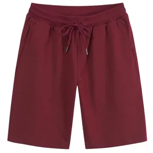 Men's dark red cotton athletic shorts featuring elastic waist and drawstring detail