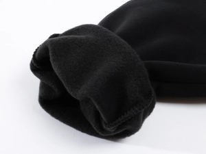 Close-up of black fleece lining on men's thermal trousers showing soft fabric texture